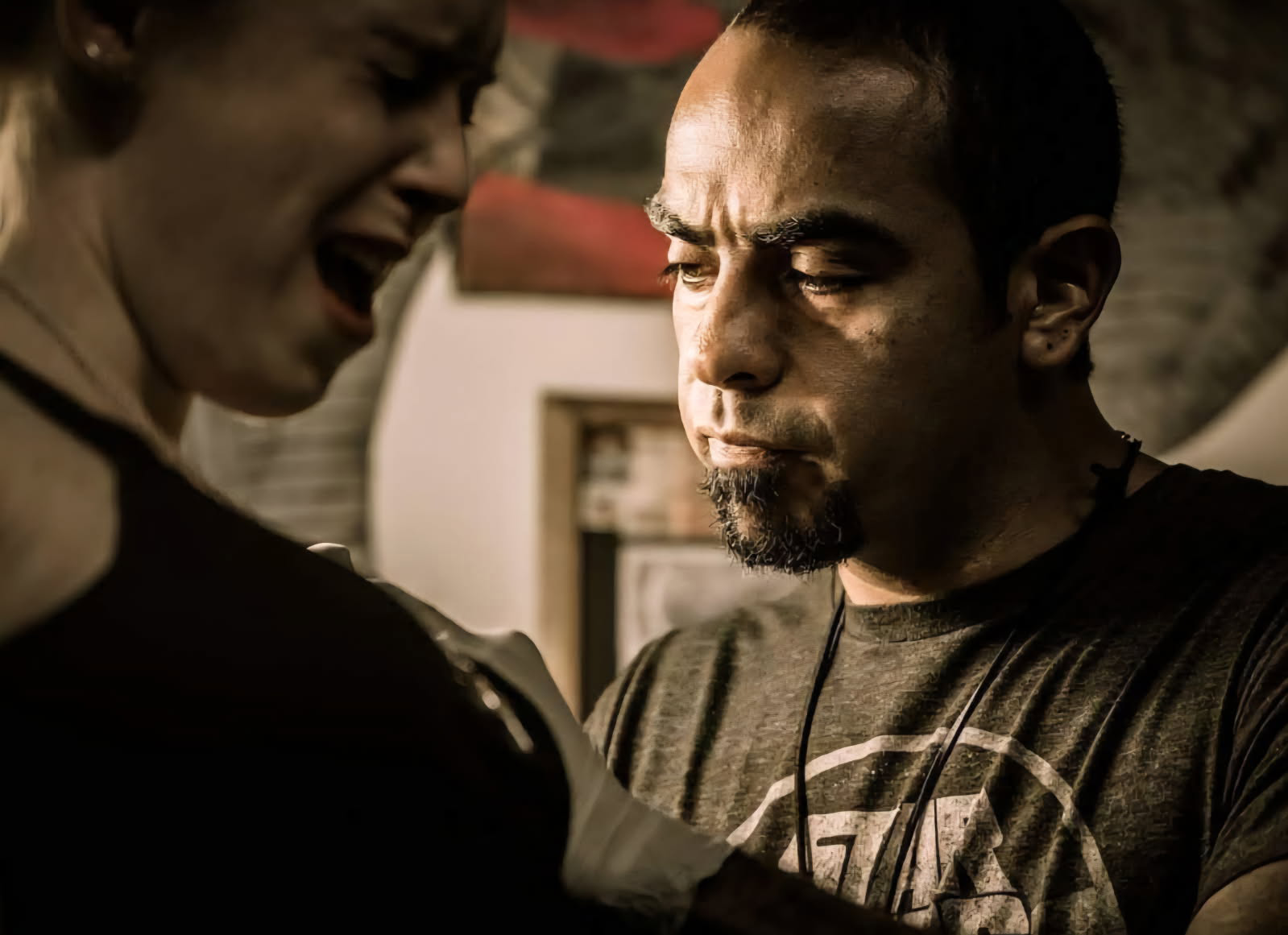 Sam Couttolenc tattooing a client